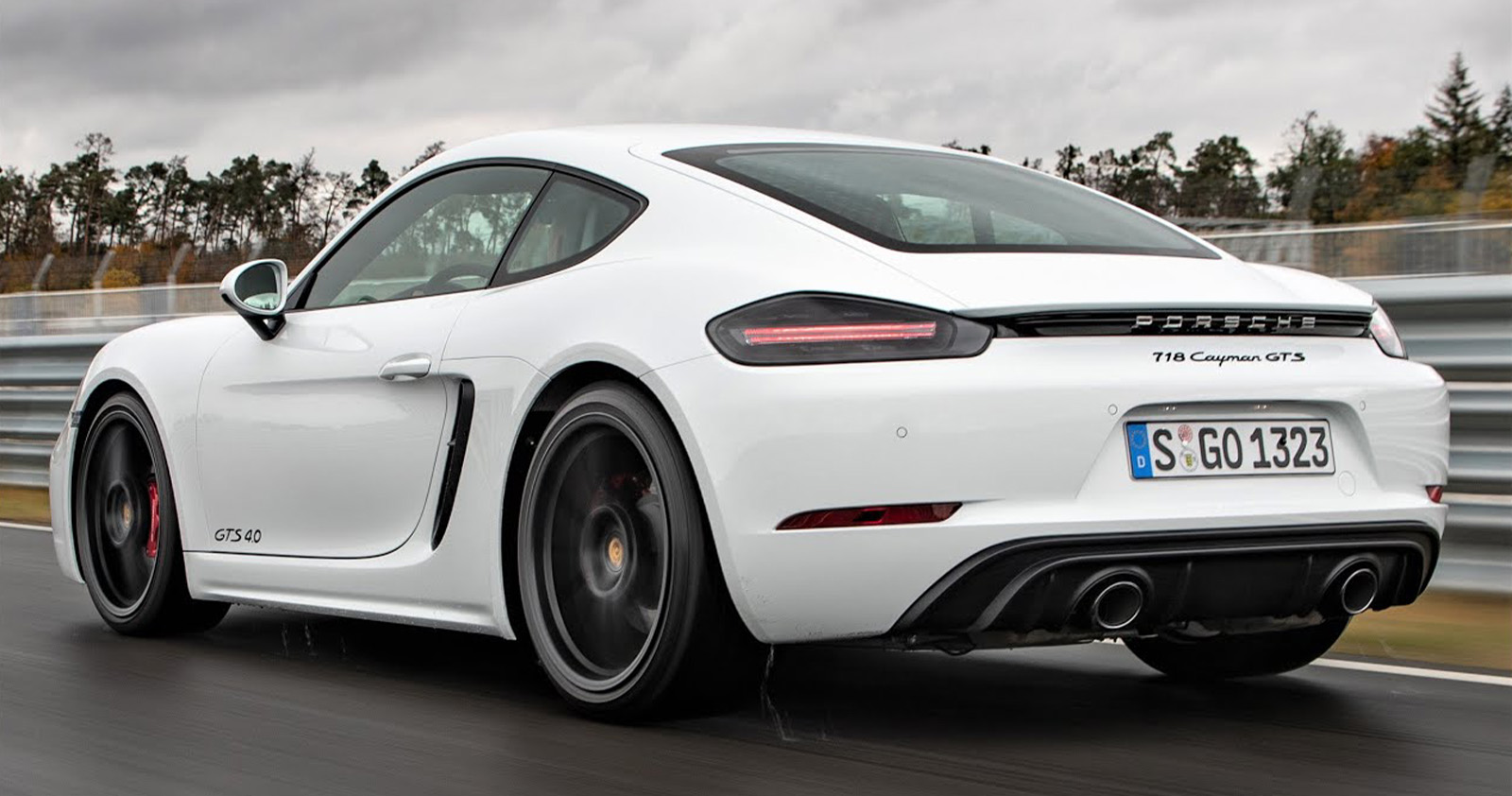 Rear end of a white Porsche 718 Cayman GTS on a track