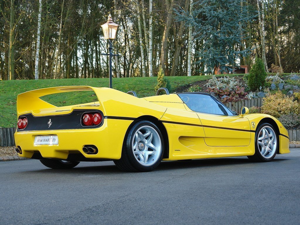 Yellow Ferrari F50 parked on street