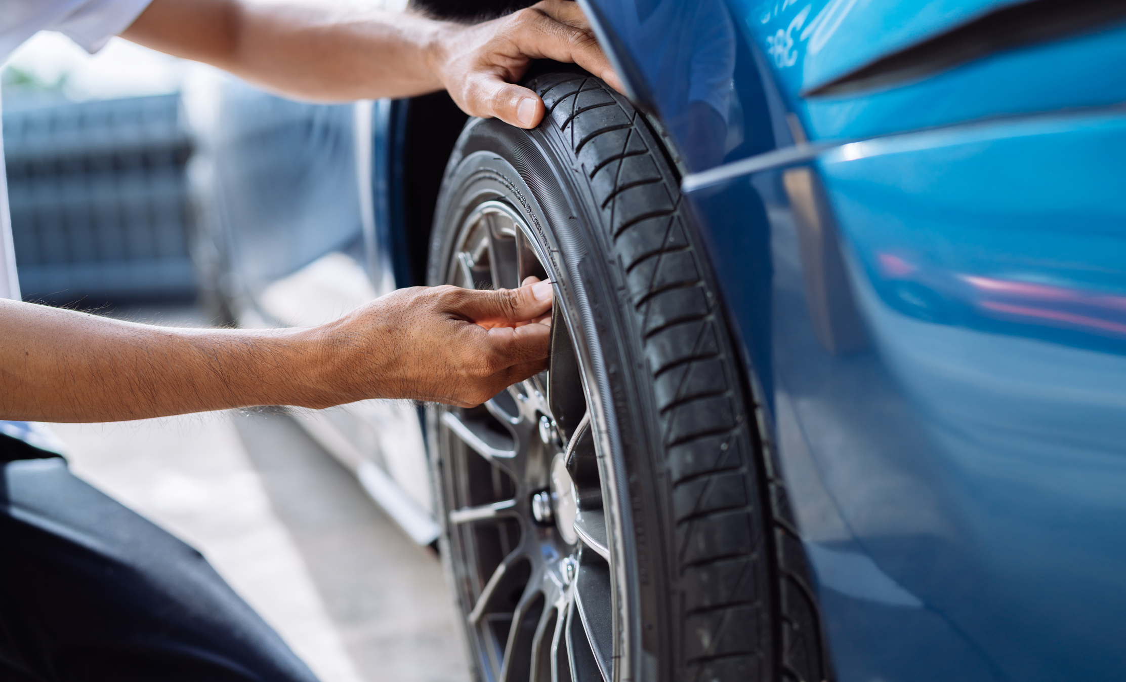 Checking the tire pressure on a car wheel